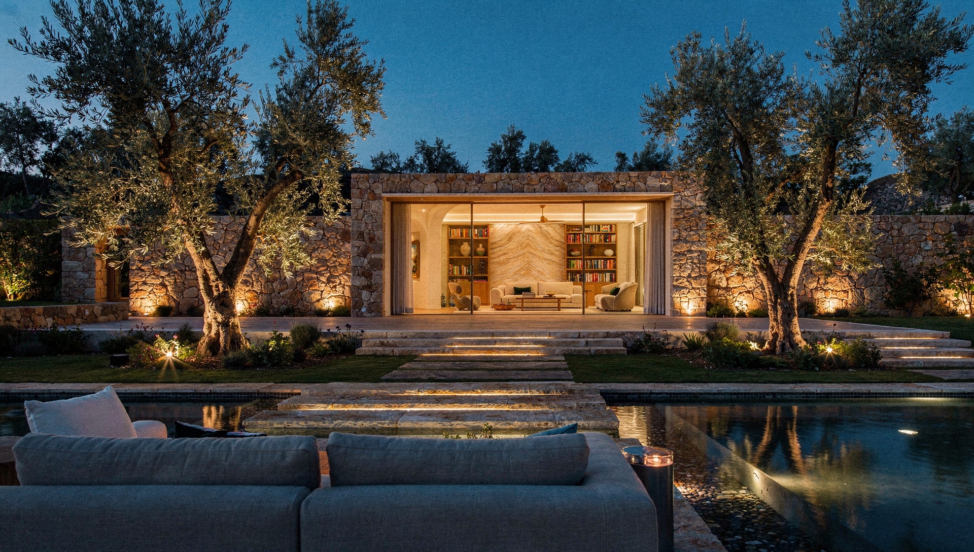 The Meshronix show-home at dusk, seen across a lit garden pool