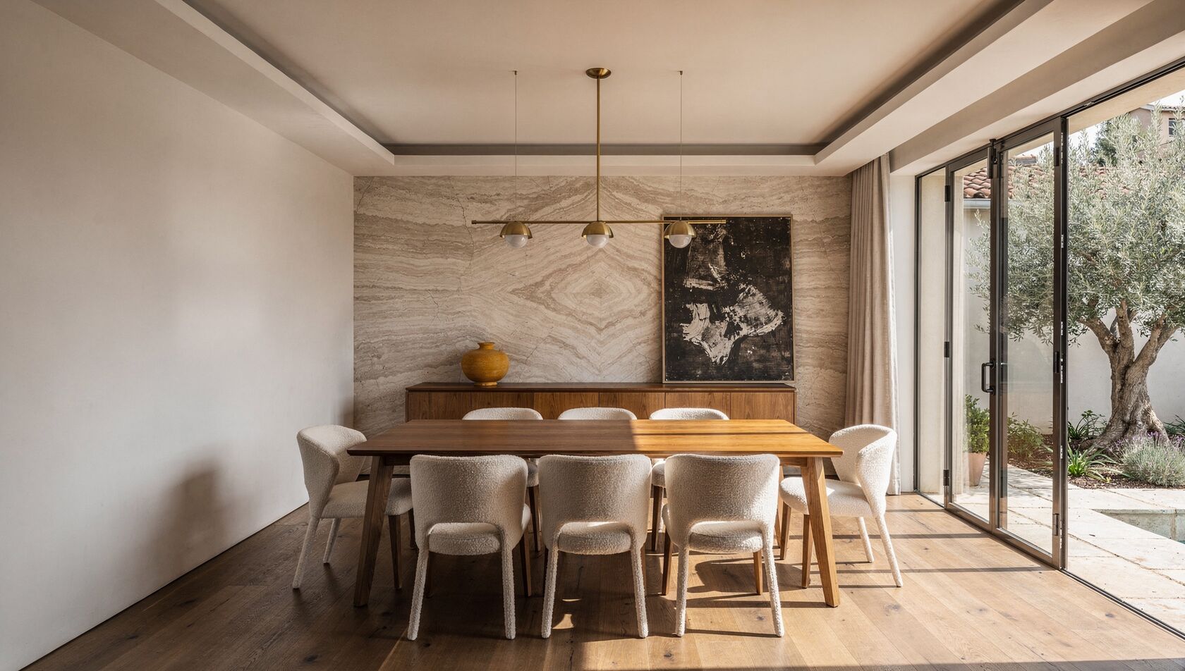 The Meshronix show-home dining room, a bookmatched-travertine wall and warm oak in soft daylight